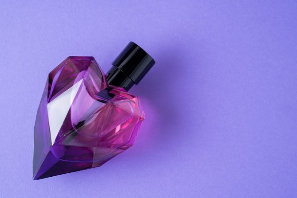 Fashion,Perfume,In,Glass,Bottle,On,Purple,Background.,Heart,Bottle